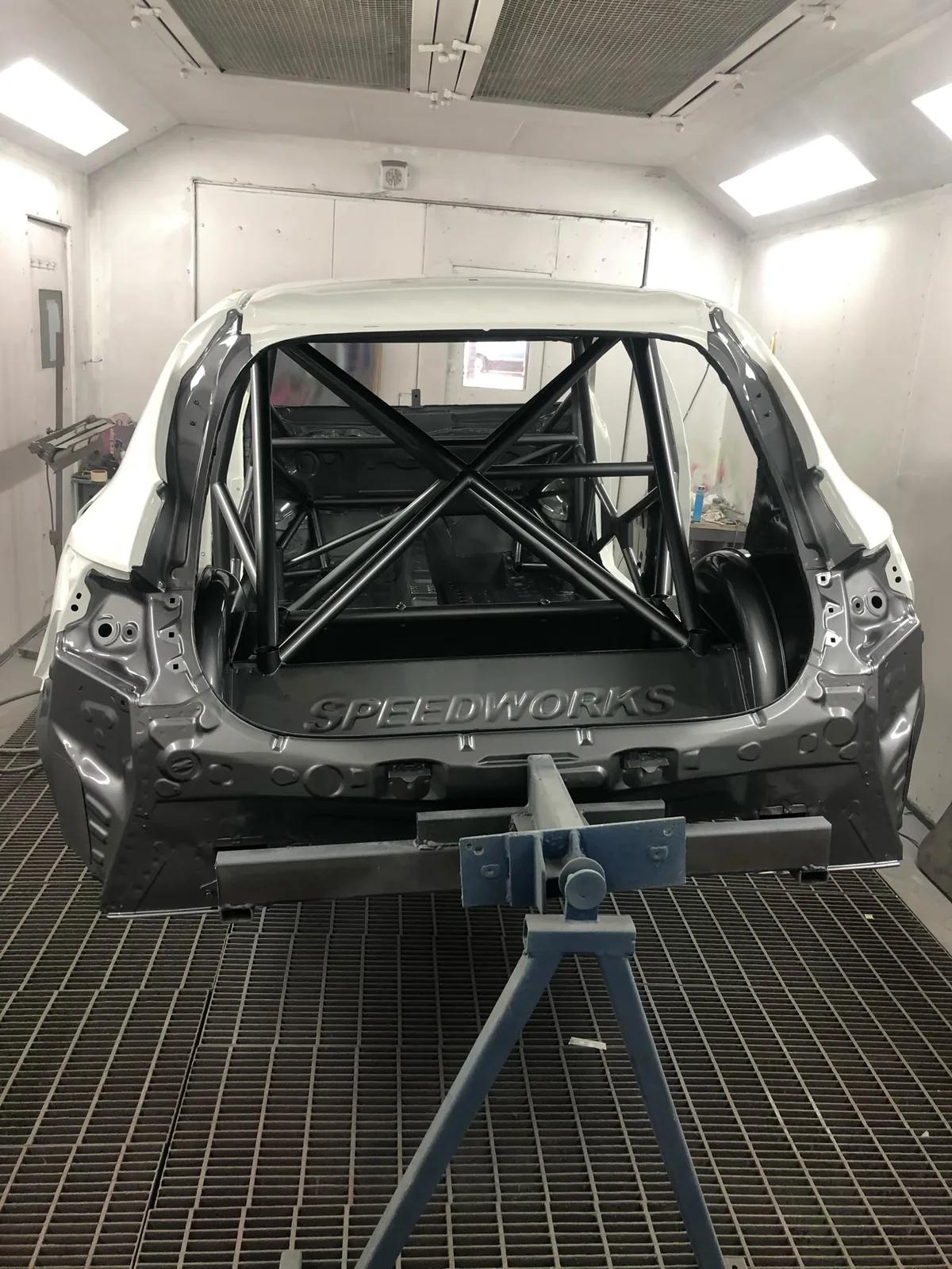 Bare restoration shell with roll cage at Welch Automotive